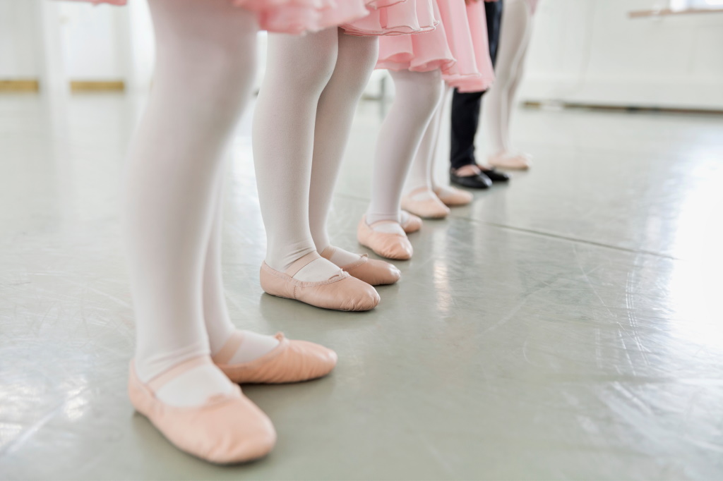 Young kids' feet with ballet shoes